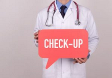 A doctor carrying a sign saying “Check Up”.