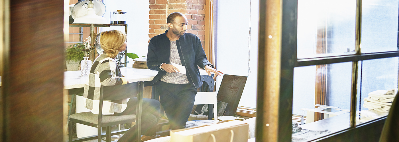 Un homme et une femme discutant dans un bureau.