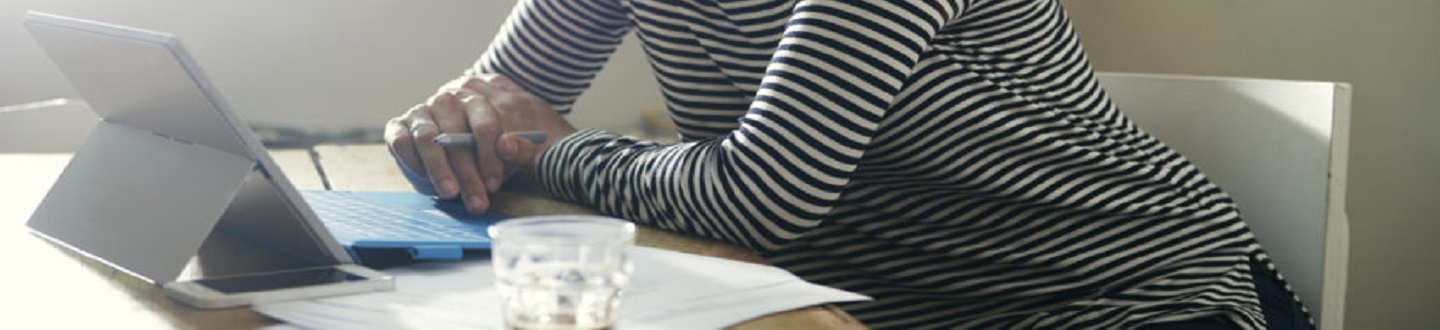 A woman working on her tablet.