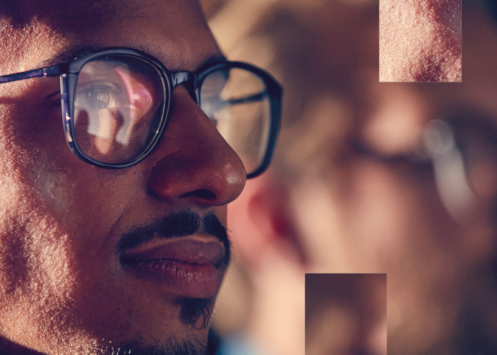 Zooming in on the face of a man wearing glasses in profile 